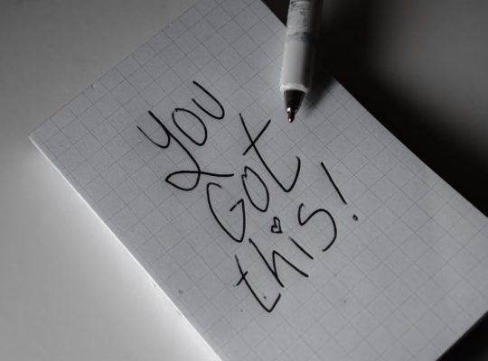 Inspirational handwritten note on graph paper with pen. Encouraging words 'You got this!'